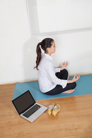 businesswoman meditating at work