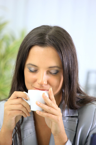 relaxed businesswoman drinking tea